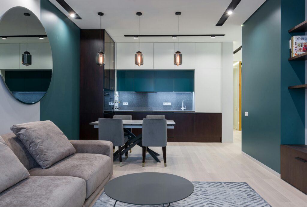 Interior of contemporary apartment with comfortable furniture in living room and kitchen in daylight
